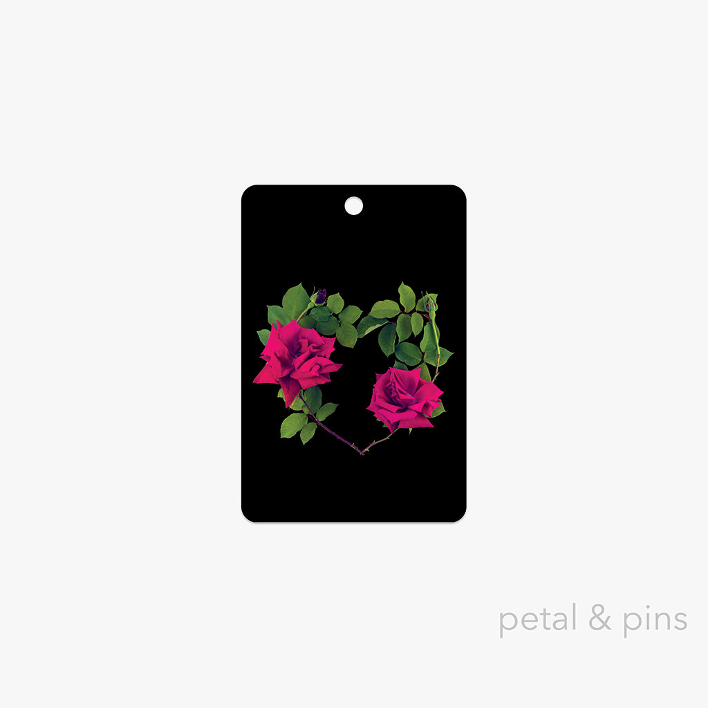 lovers rose gift tag by petal & pins featuring a heart-shaped arrangement of red roses with green leaves on a black card