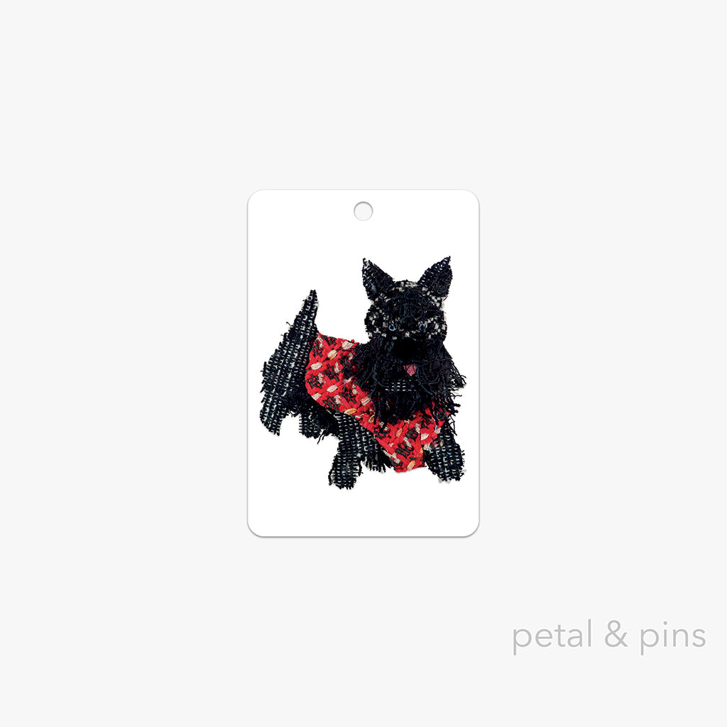 scottie dog gift tag by petal & pins featuring a black scottie dog wearing a jaunty red vest on a white background