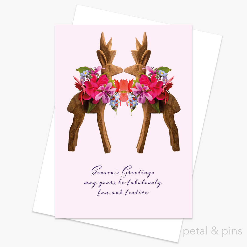 Greeting card with floral reindeer design and 'Season's Greetings' text on a pink background from petal & pins.