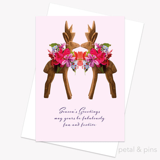 Greeting card with floral reindeer design and 'Season's Greetings' text on a pink background from petal & pins.