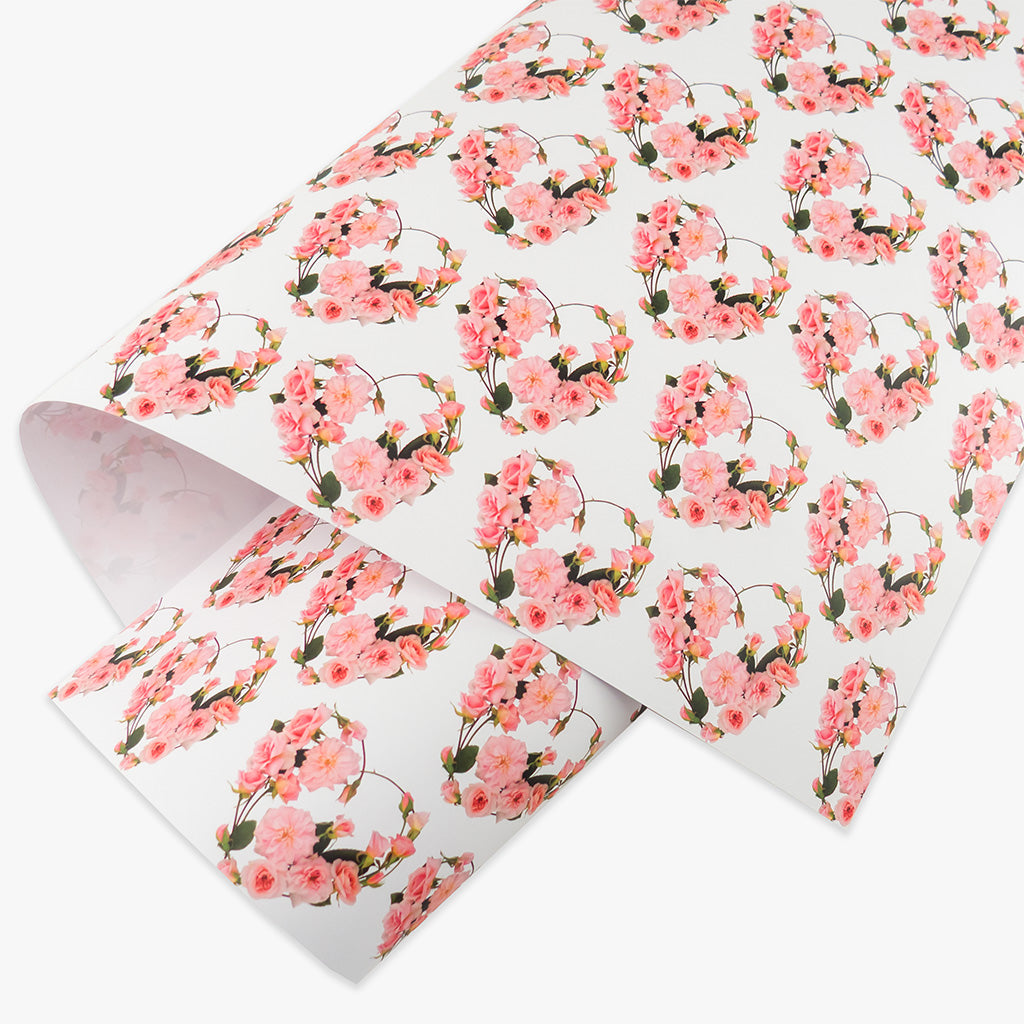 Rose hearts wrapping paper by petal & pins. Floral patterned paper with pink flowers and green leaves on a white background.